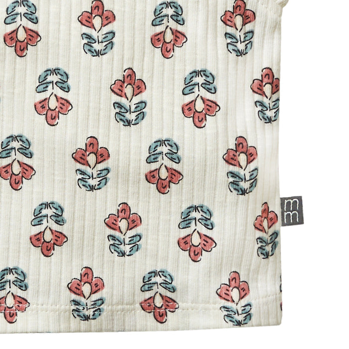 Textile with floral pattern and 'm' brand logo on a white background