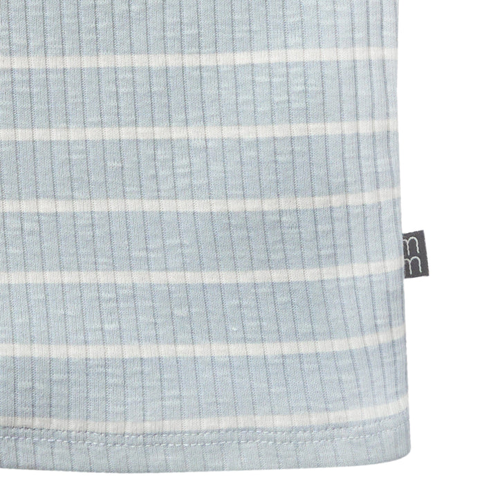Close-up of a textured fabric with horizontal stripes and a brand tag on a white background