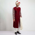 Burnt red velvet form-fitted sherwani featuring intricate detailing and a luxurious finish by Arsalan Iqbal, perfect for formal occasions.