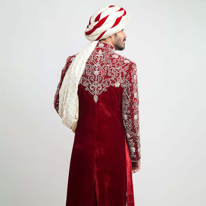 Burnt red velvet form-fitted sherwani featuring intricate detailing and a luxurious finish by Arsalan Iqbal, perfect for formal occasions.