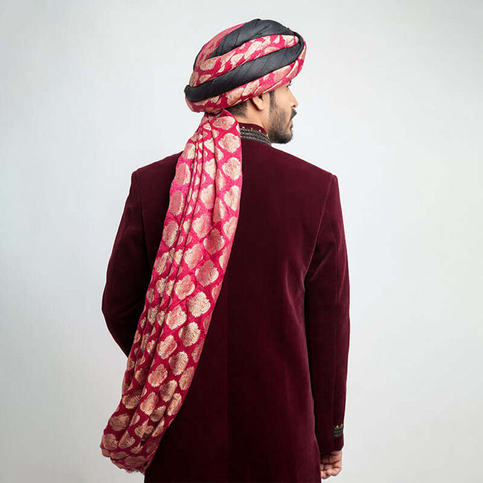 Back view of an Arsalan Iqbal maroon velvet sherwani showing the elegant drape of a pink and gold brocade turban.