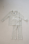 The forever french baby Girl’s Bamboo Button Up Lounge Set | Dainty Vines features soft, hypo-allergenic children’s pajamas with long sleeves and pants in white with green and gold vertical stripes, shown flat on a white surface.