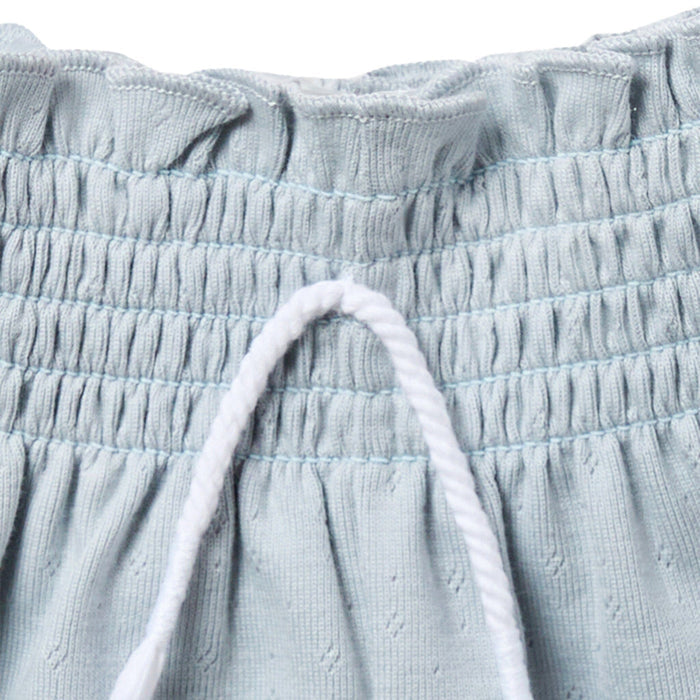 Close-up of light blue textured fabric with drawstring