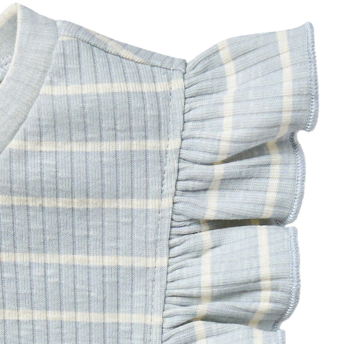 Close-up of a baby outfit with ruffled sleeves on a white background
