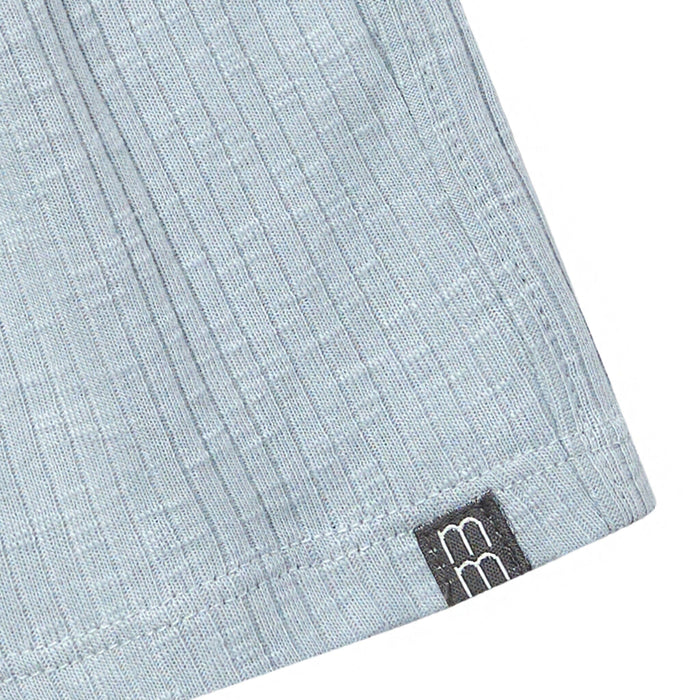 Close-up of a light blue fabric with a brand logo on a white background
