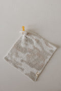The forever french baby Lovey | Camo 2.0 is a soft, square microfiber plush with a neutral camo pattern and an attached pacifier, perfect for comfort and security.