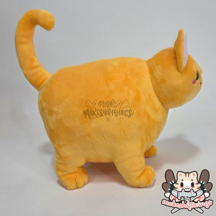 Orange fat cat in a sweater